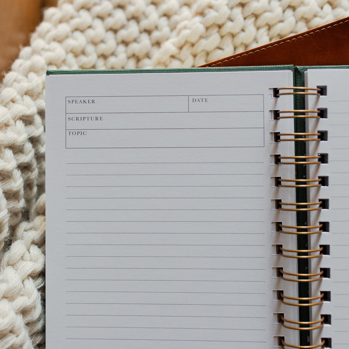 Up close of The Sermon Notes Journal with Green Floral on a bible and a knitted blanket