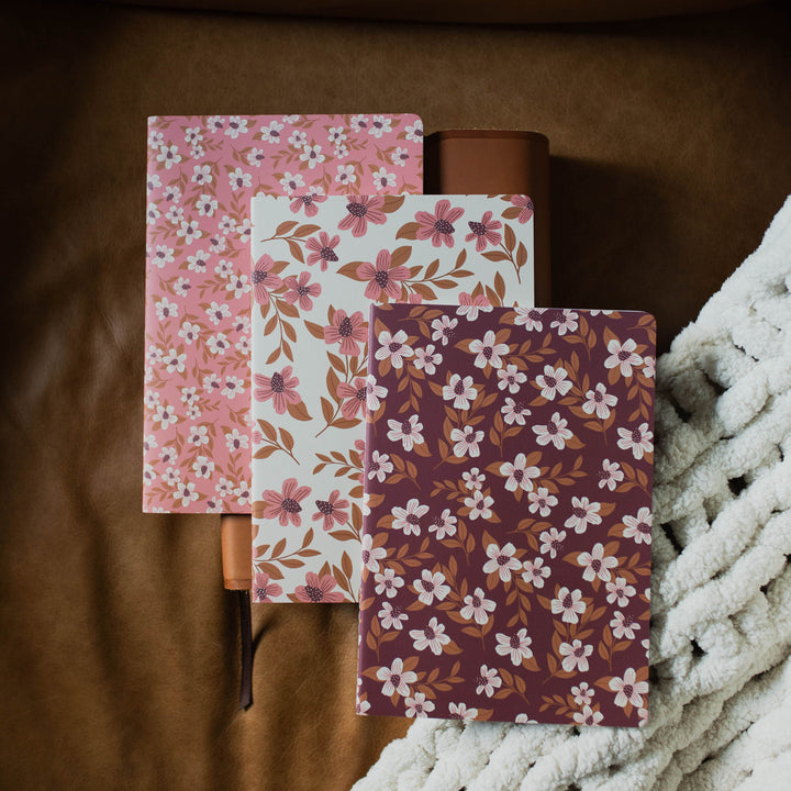 3 stitched journals with lined pages and floral patterns