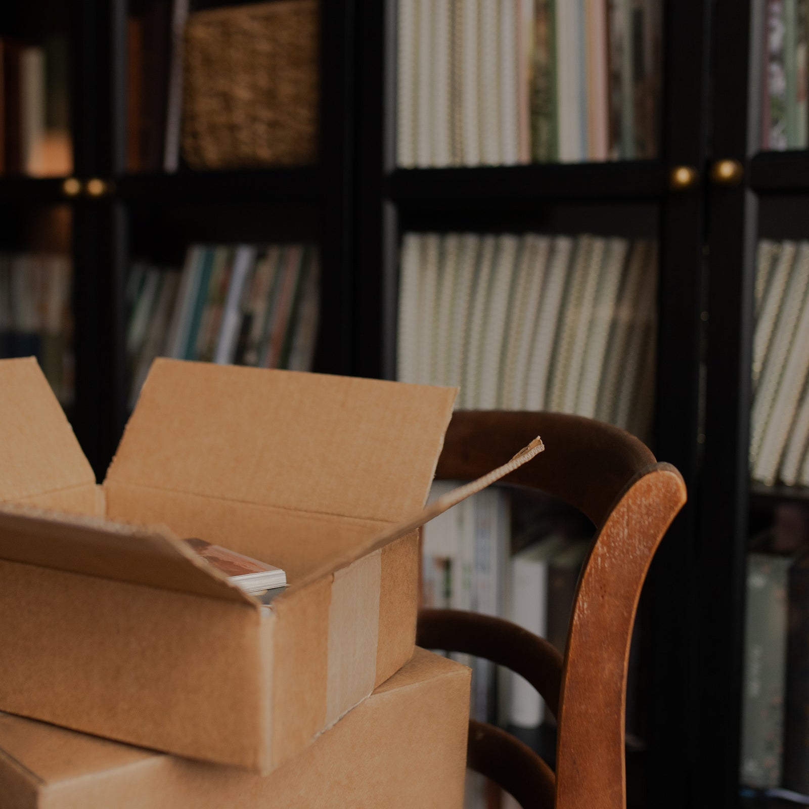 Open cardboard box with books in a library setting