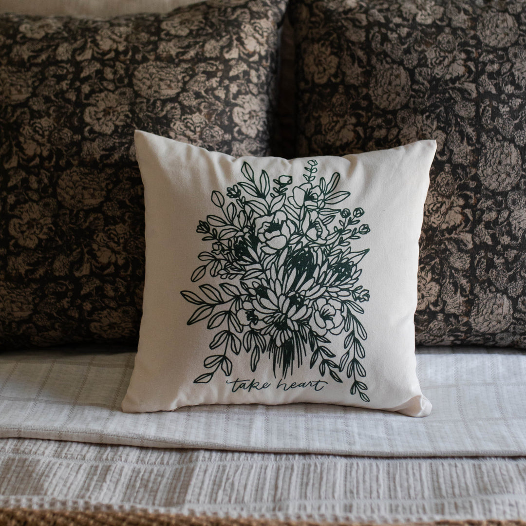 Take heart floral pillow cover on a bed as decoration