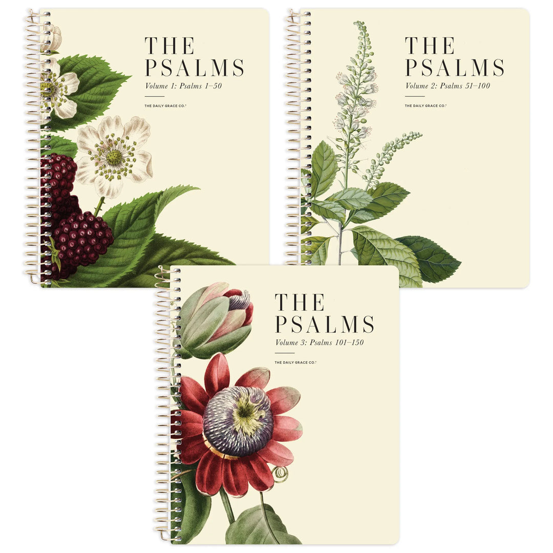 Three spiral-bound books titled "THE PSALMS" arranged on a white background, each with a different botanical cover illustration: cream with white flowers and berries, cream with green leaves, and cream with a red flower.