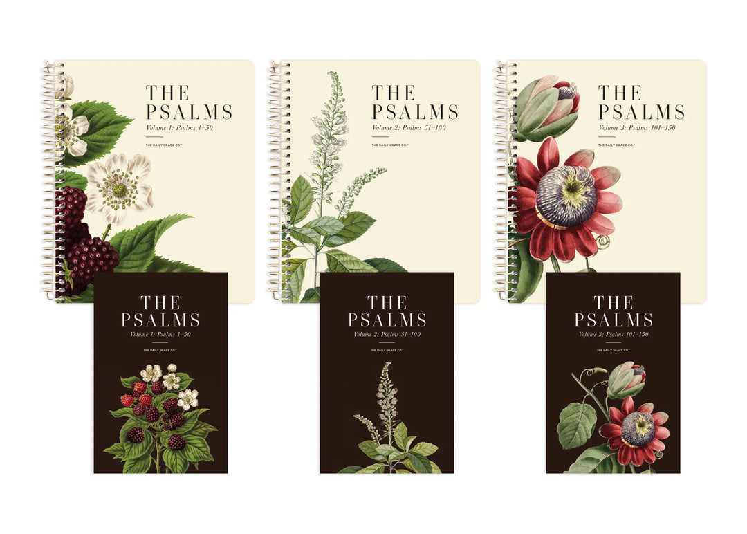 Three spiral-bound books titled "THE PSALMS" arranged in a clean studio layout. The top row has cream covers with botanical illustrations, and the bottom row has dark brown covers with matching floral artwork.