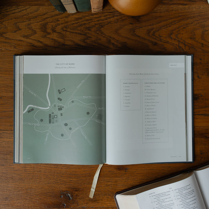 The Bible Maps Handbook opened to the City of Rome page on a wooden table near an open bible