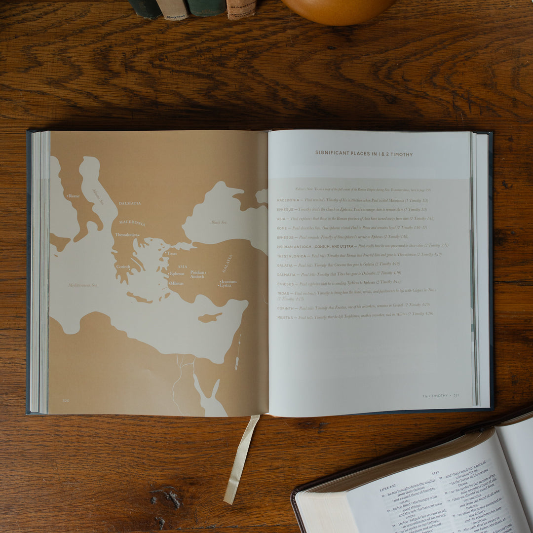 The Bible Maps Handbook opened to the Significant Places in 1 & 2 Timothy page on a wooden table near an open bible