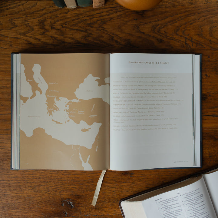 The Bible Maps Handbook opened to the Significant Places in 1 & 2 Timothy page on a wooden table near an open bible