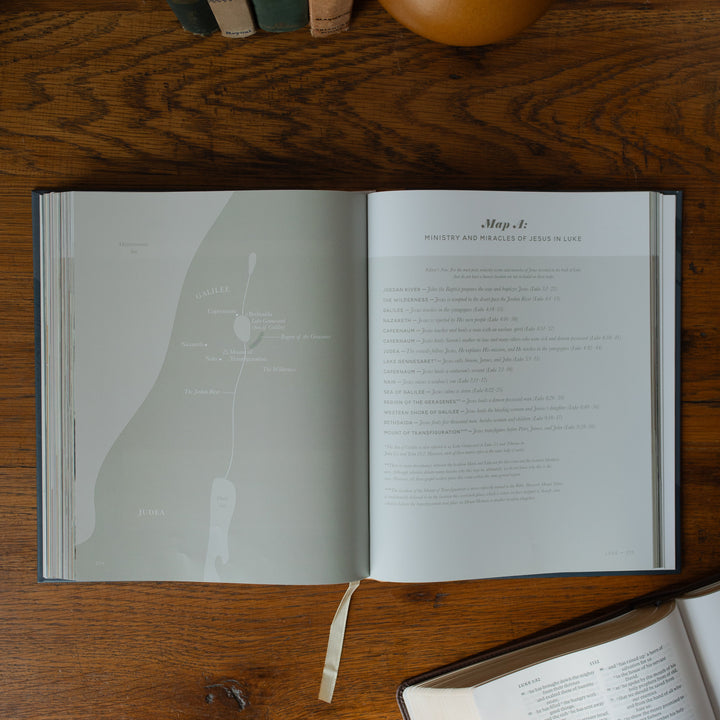 The Bible Maps Handbook opened to the map A page on a wooden table near an open bible