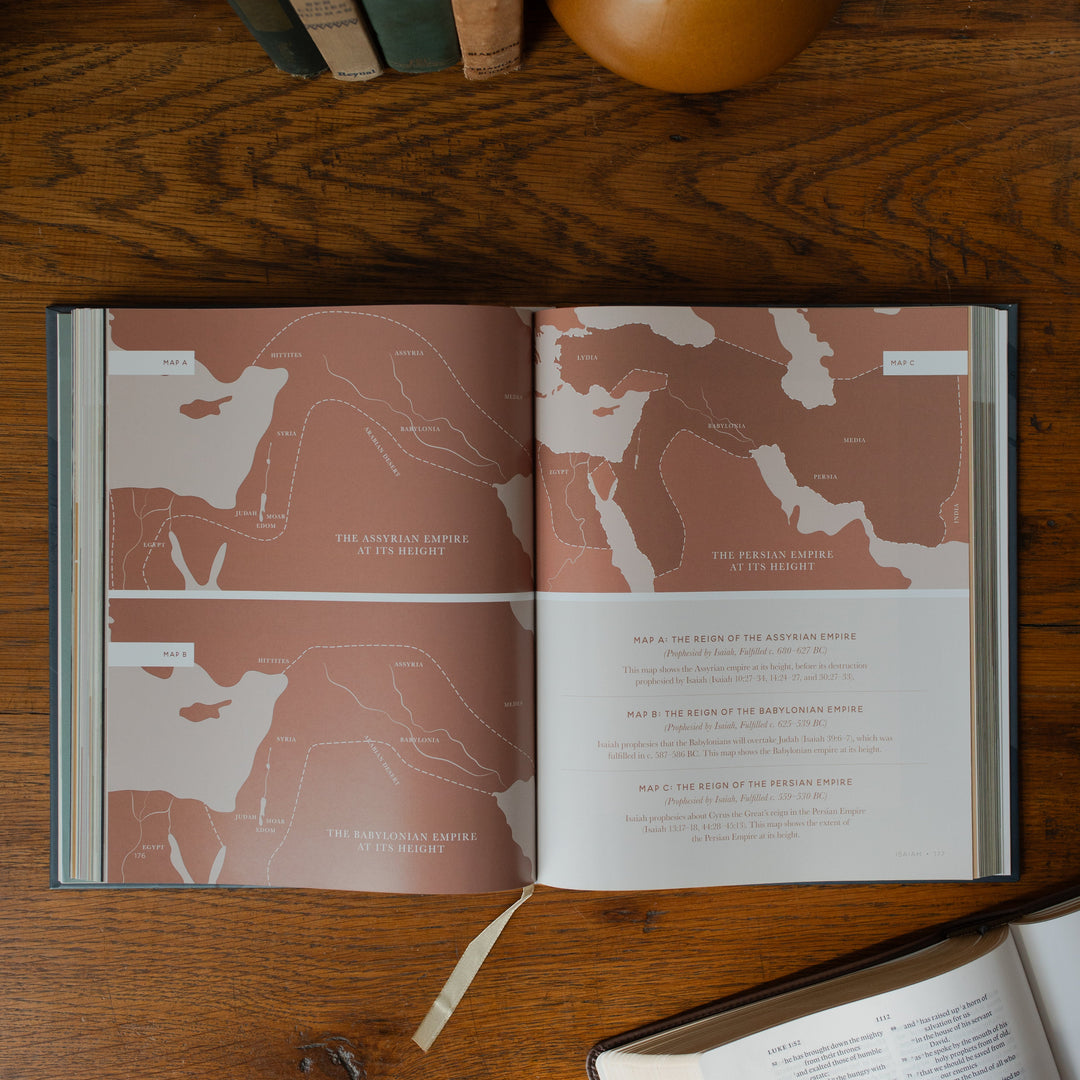 The Bible Maps Handbook opened to the Map A, B, and C page on a wooden table near an open bible