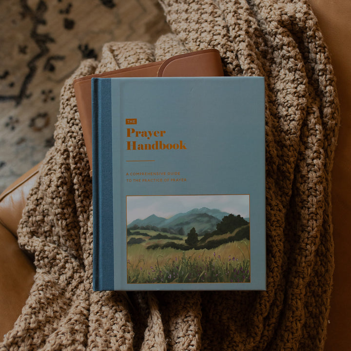 Book on prayer sitting on blanked