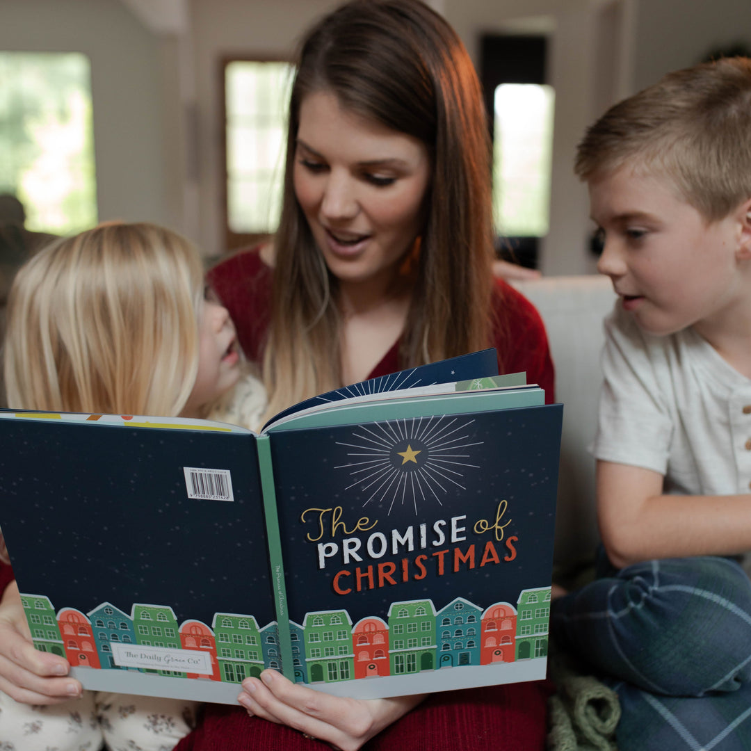 Mother with two children reading The Promise of Christmas children's Christmas book 