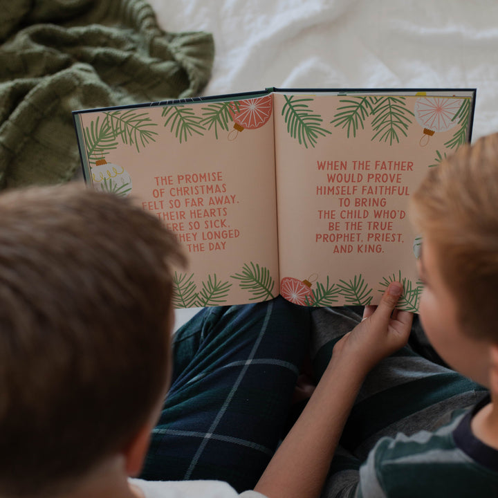 Children reading Christmas book The Promise of Christmas