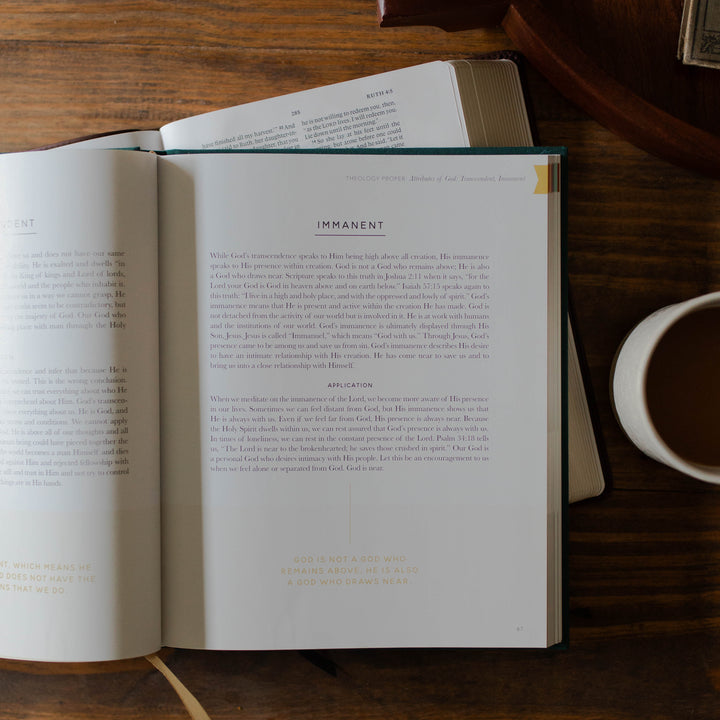 Open theology book on a wooden table with a cup of coffee