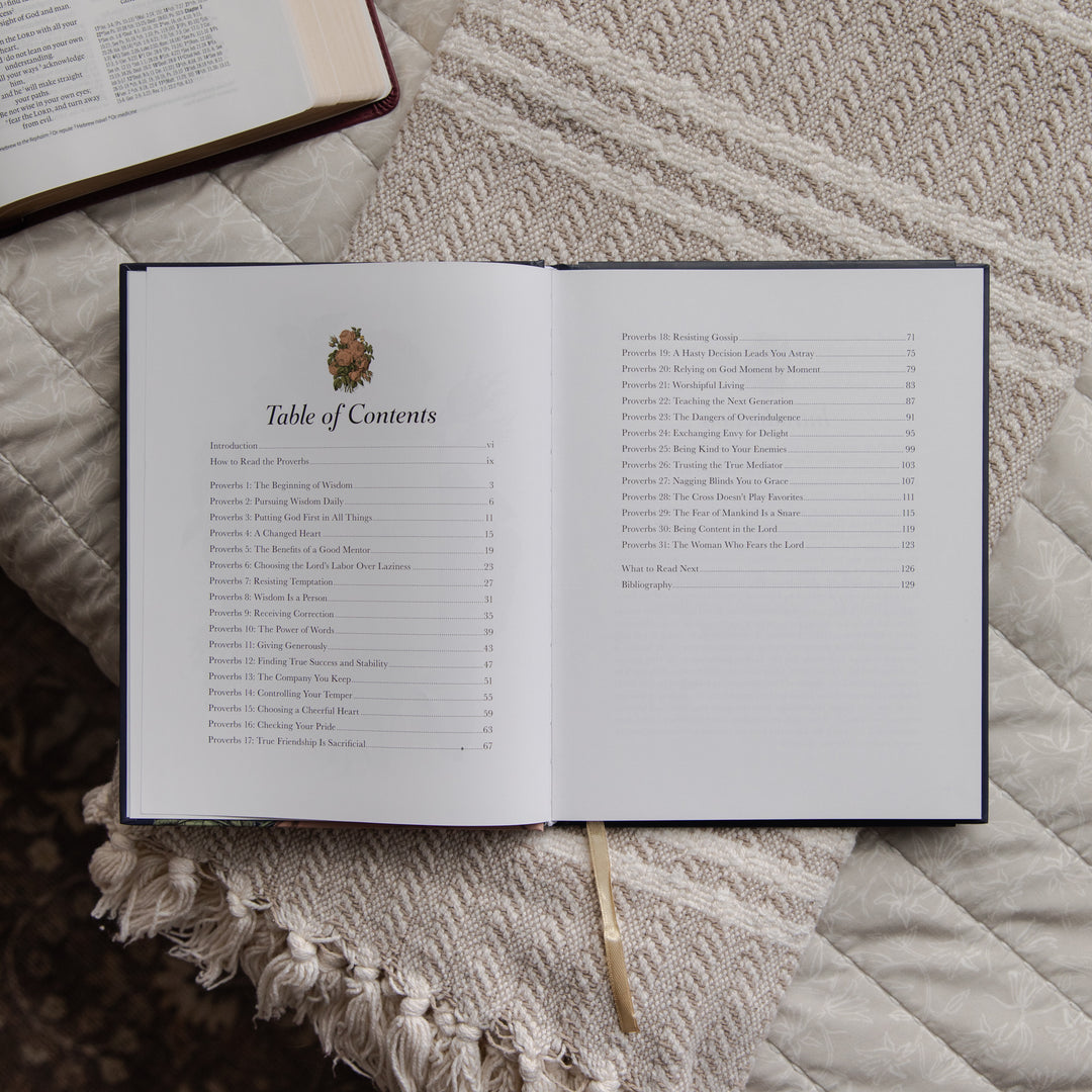 Open devotional with table of contents on a textured surface