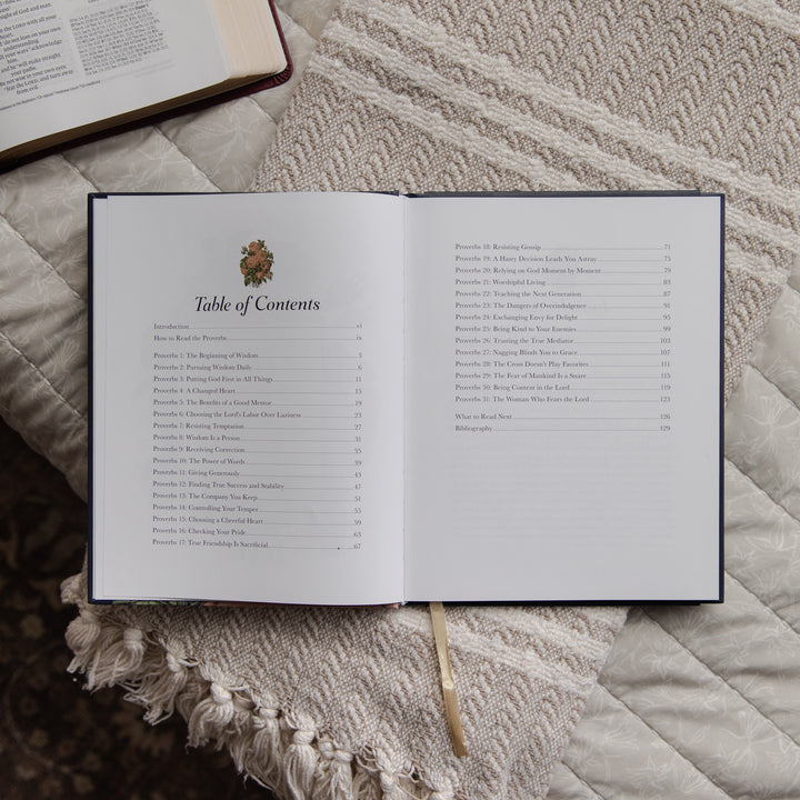 Open devotional with table of contents on a textured surface
