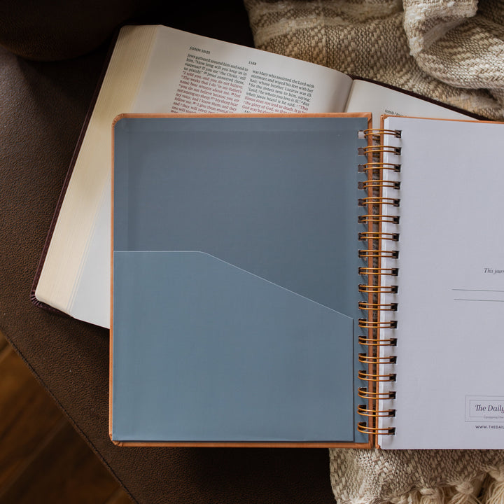 Theologian Journal opened to the inner pouch on an open bible