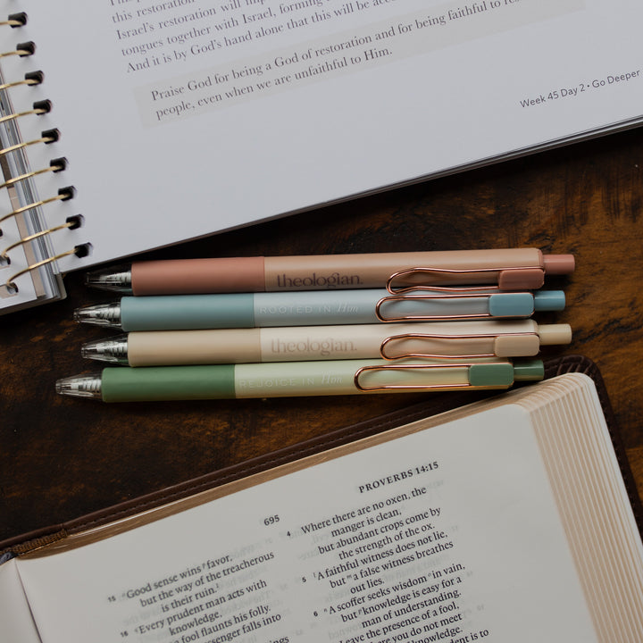 4 Theologian Pens laying above an open bible and below an open bible study