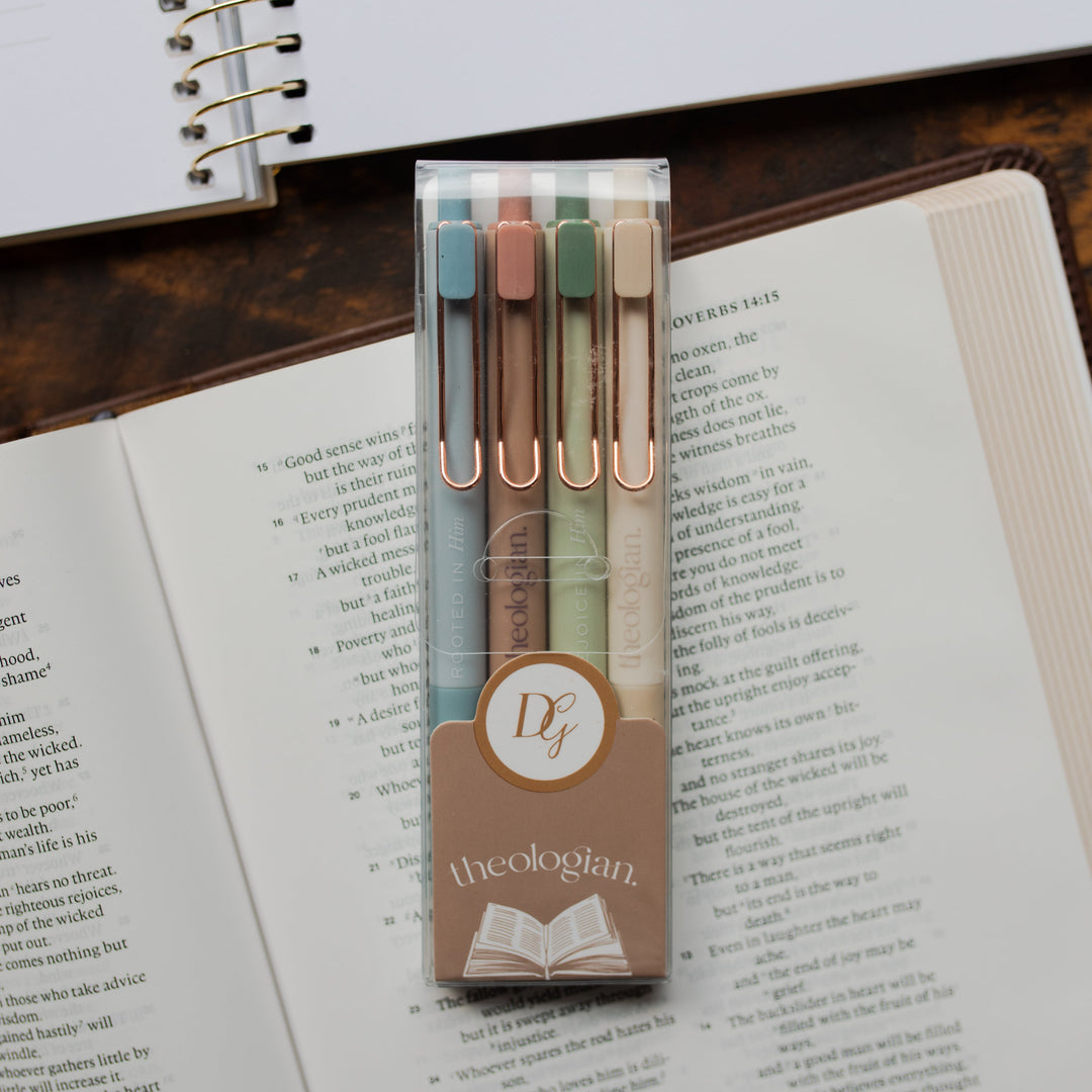 A package of 4 Theologian Pens laying on an open bible