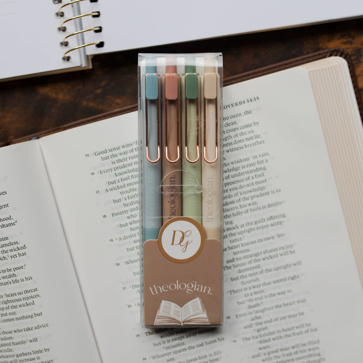 A package of 4 Theologian Pens laying on an open bible