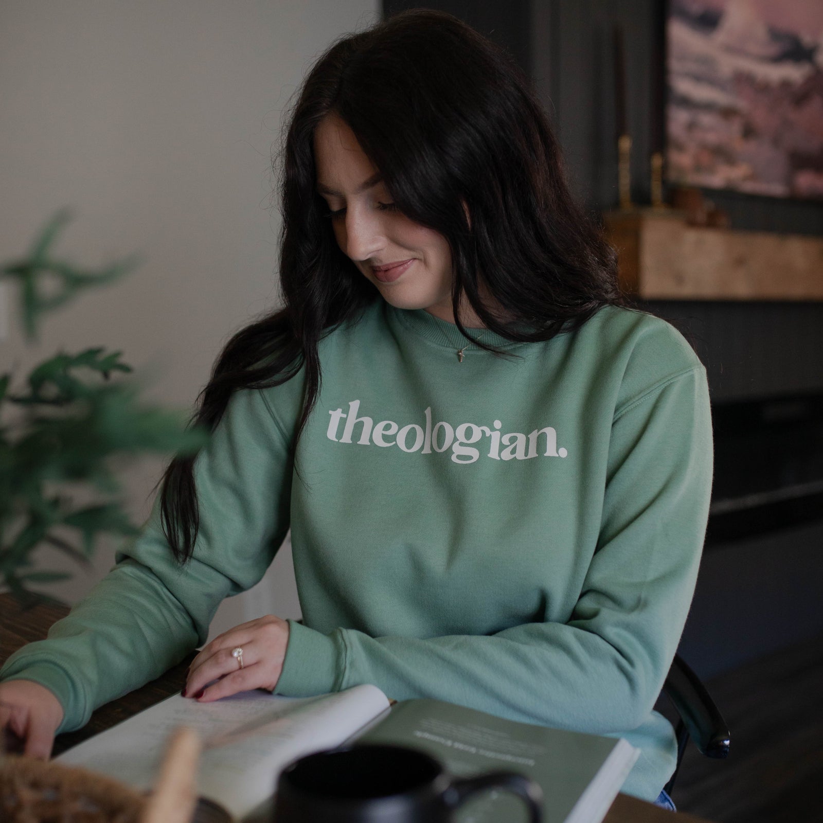 Woman wearing theologian sweatshirt while doing a Bible study