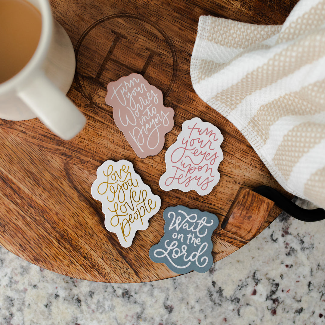 photo of 4 magnets laid out on a tray next to coffee mug