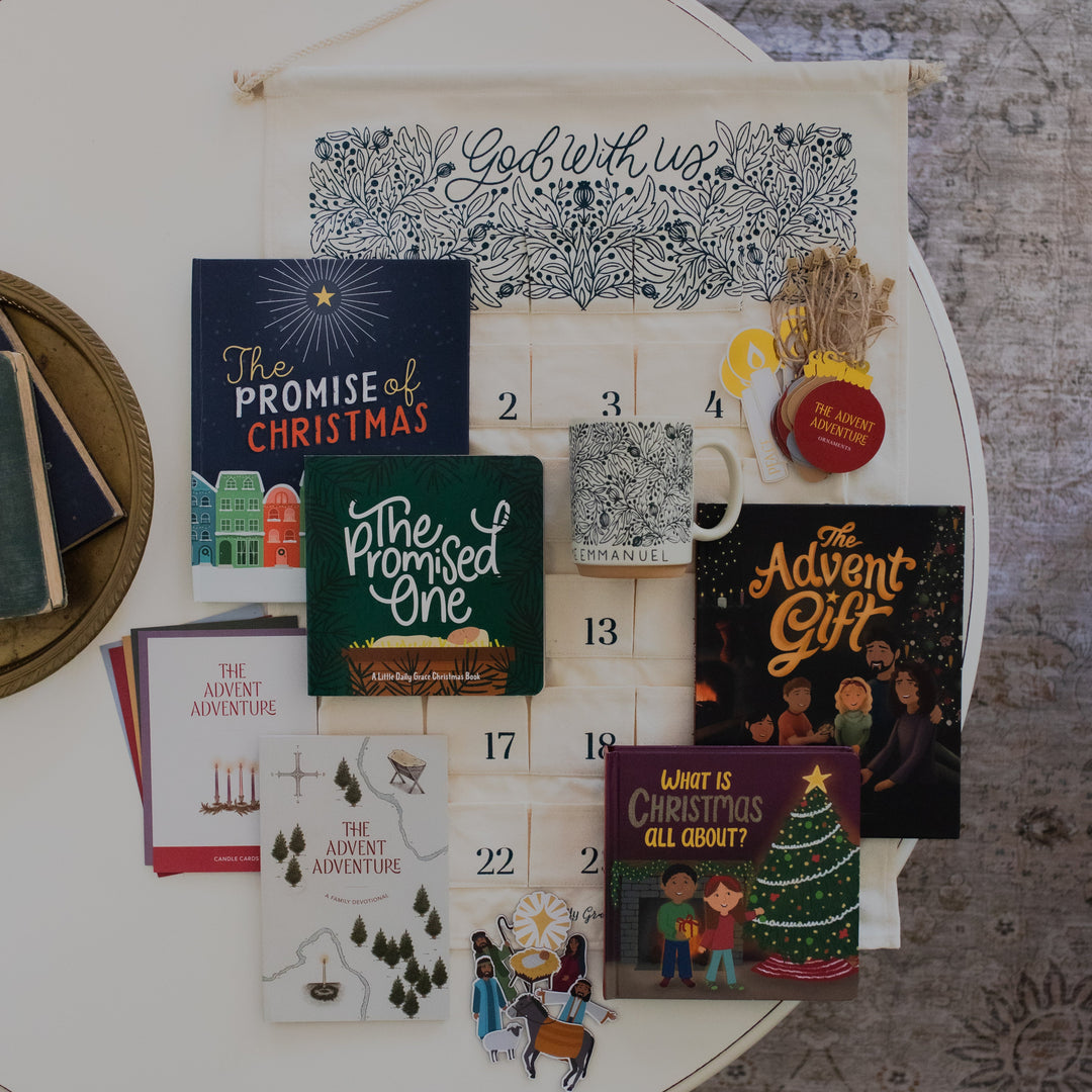Ultimate Family Bundle with the Emmanuel Mug on a white table and next to some various books