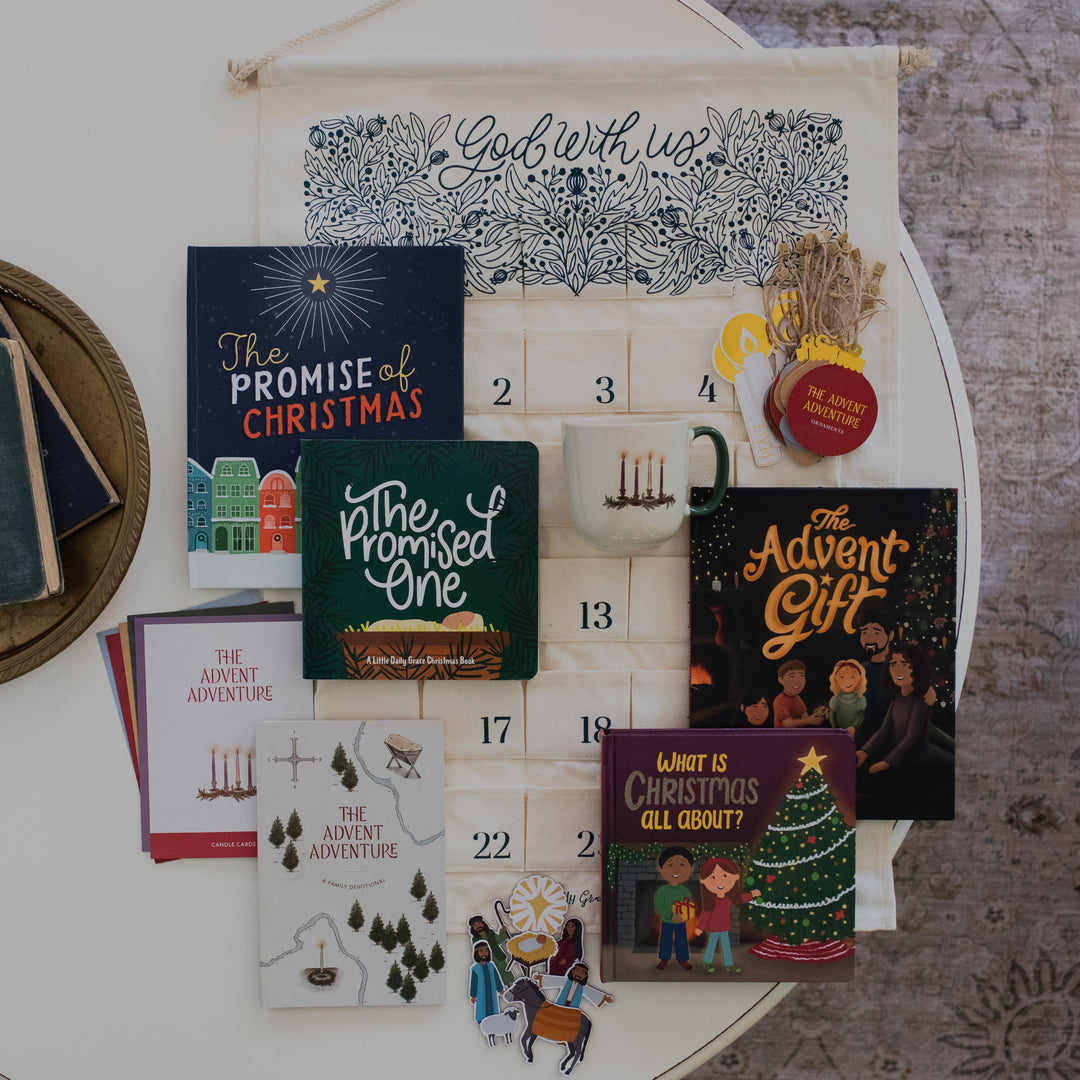 Ultimate Family Bundle with the Candle Mug on a white table and next to some various books