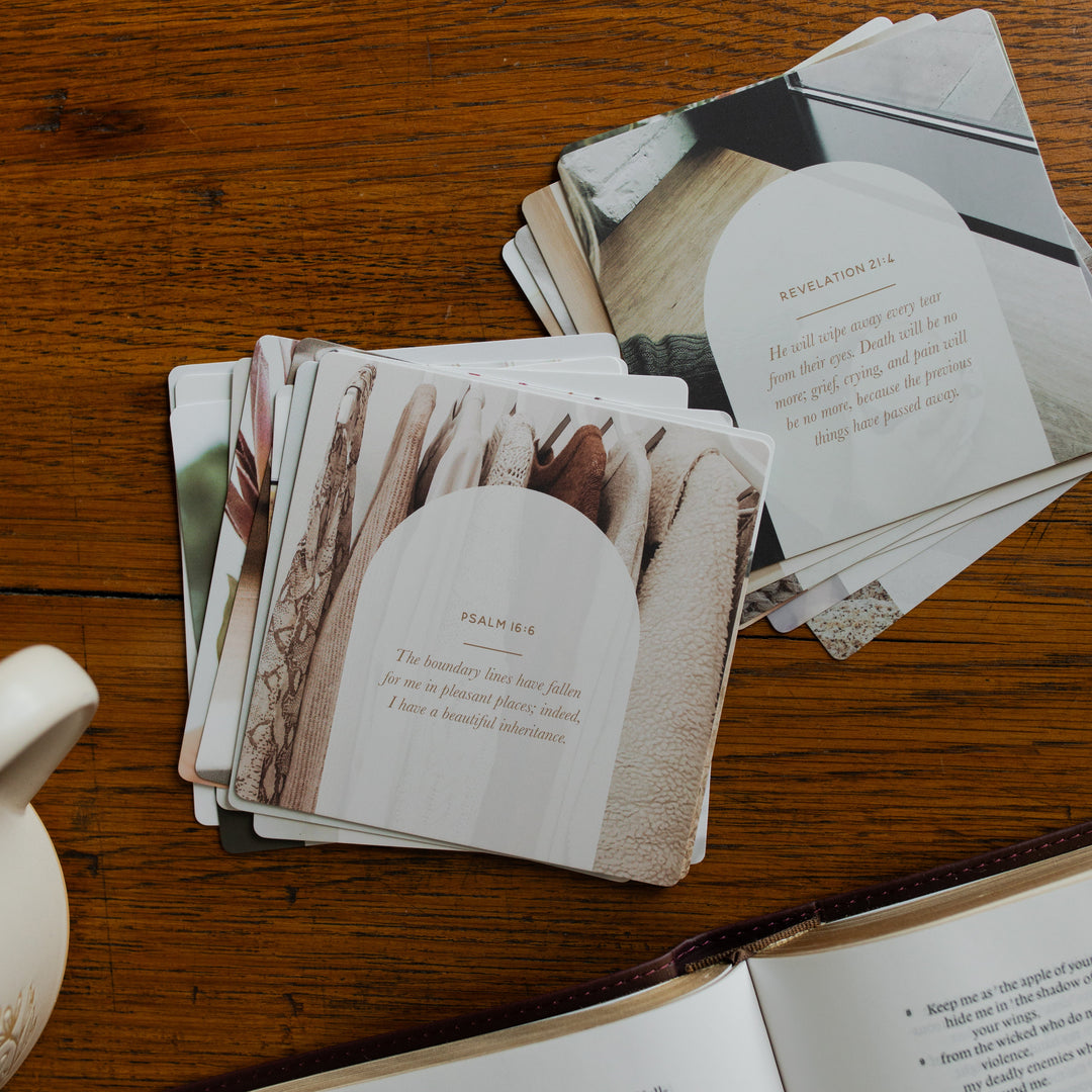 2 stacks of the Verse Cards for Depression on a wooden table next to a coffee cup