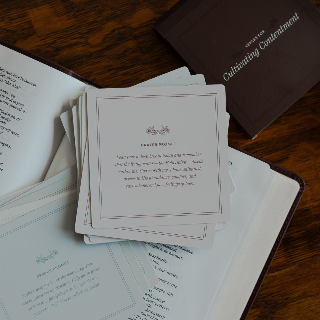 Verses for Cultivating Contentment verse cards with the prayer prompt side up on an open bible