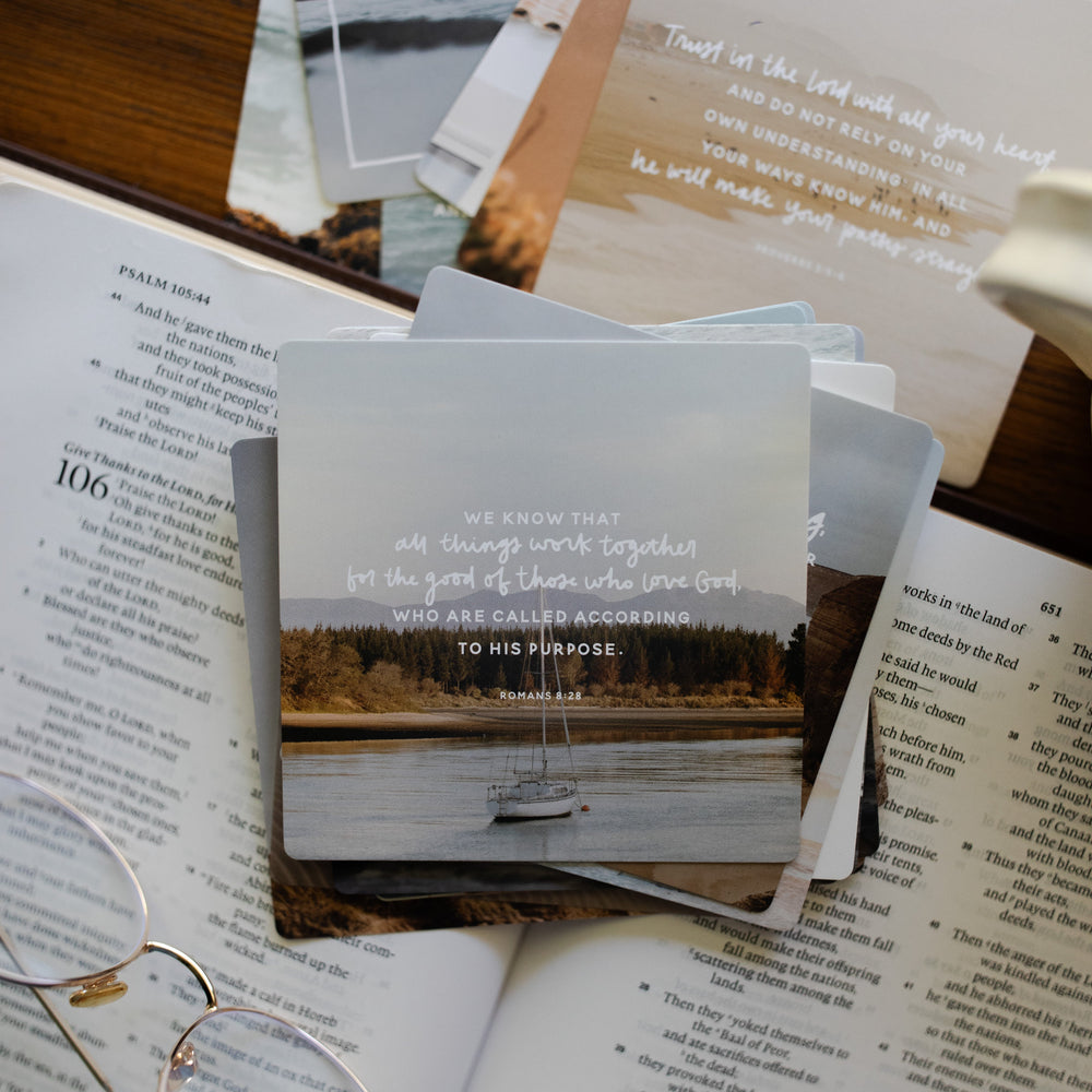 Verse cards for Uncertainty backs laying on an open bible next to a pair of glasses