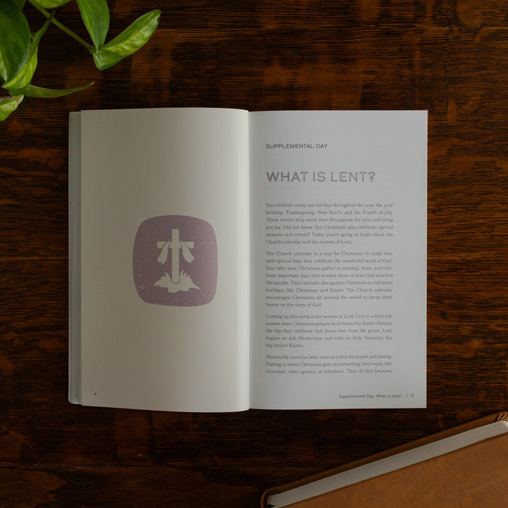 Walking with Jesus Study opened to the What is Lent page on a wooden table near some greenery and a closed journal