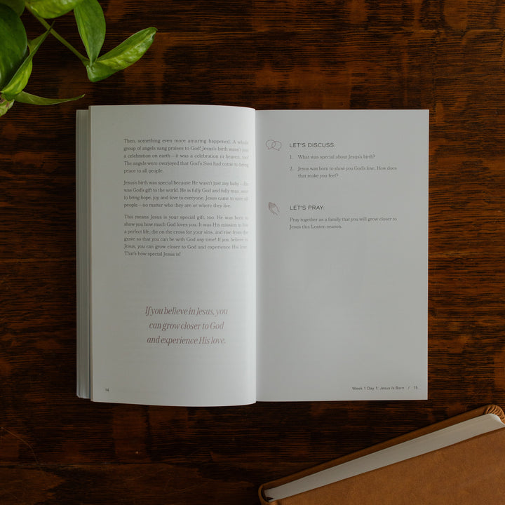 Walking with Jesus Study opened to the Devotional and discussion page on a wooden table near some greenery and a closed journal