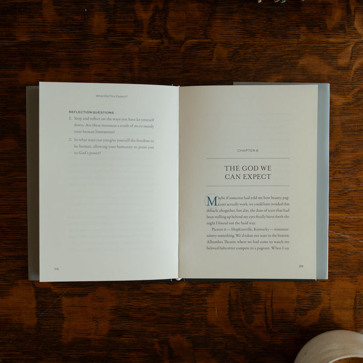 What did you expect book opened to the chapter 6 page on a wooden table near a coffee cup