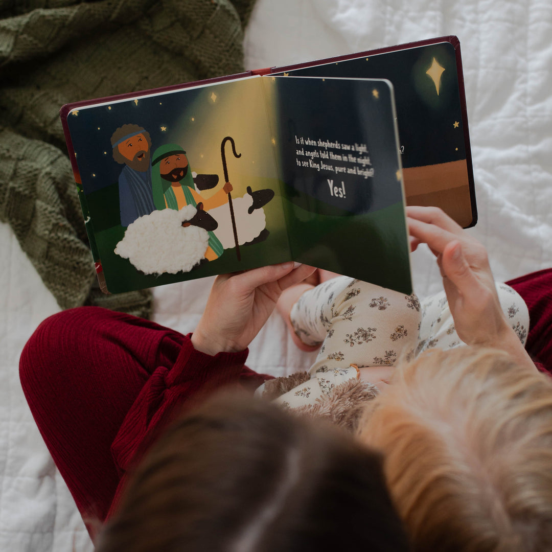 Mom flipping the pages of What Is Christmas All About? Children's board book