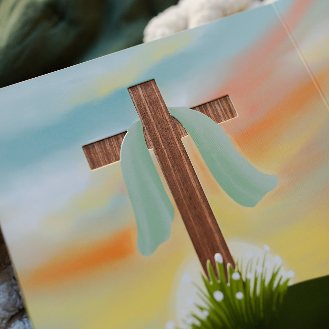 What is Easter All About Kids Book opened to the wooden cross page close up