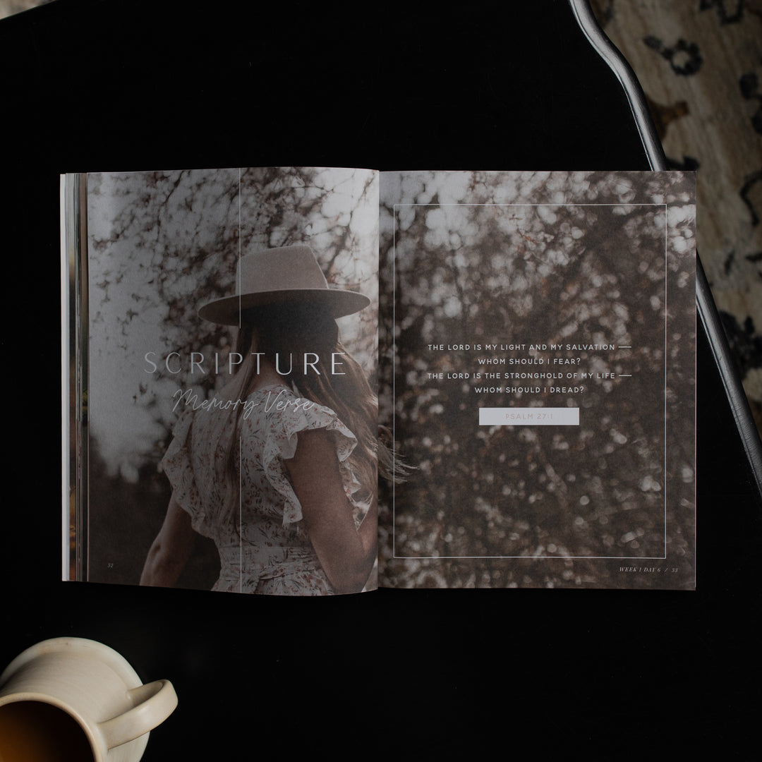 Book titled 'Scripture' with a person wearing a hat on a nature-themed cover