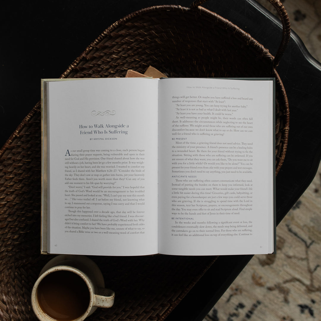 When Storms Rage opened to the How to Walk Alongside a Friend Who Is Suffering Page on other books near a coffee cup in a woven basket