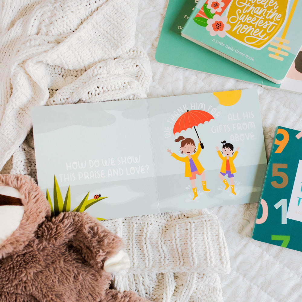 Children's board book open sitting open on blanket