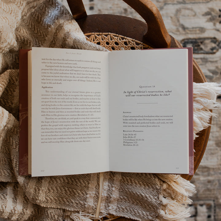 Why Did Jesus Have To Die opened to the questions 14 page on a blanket and a woven chair