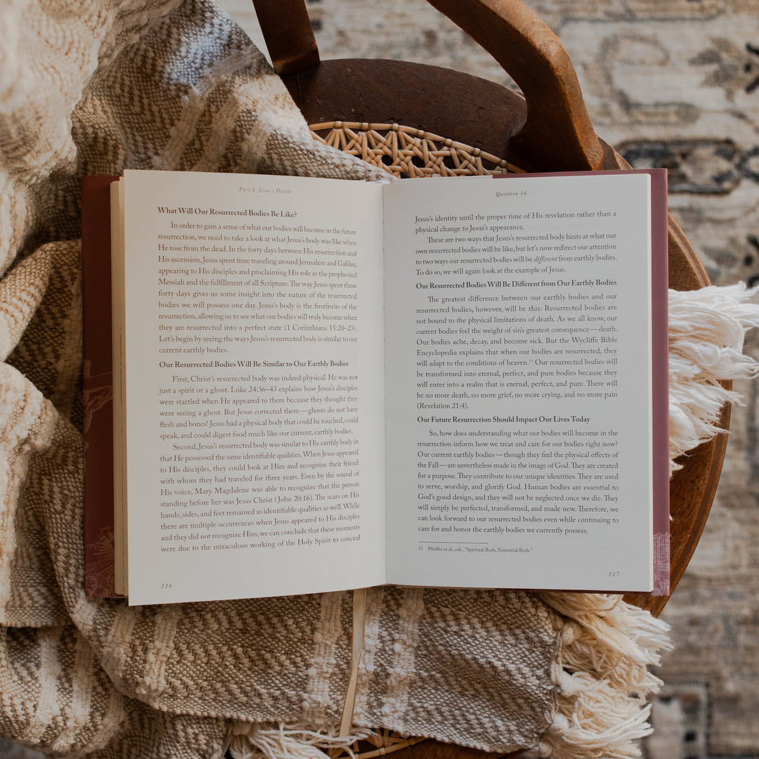 Why Did Jesus Have To Die opened to the Jesus's Death Questions 14 page on a blanket and a woven chair