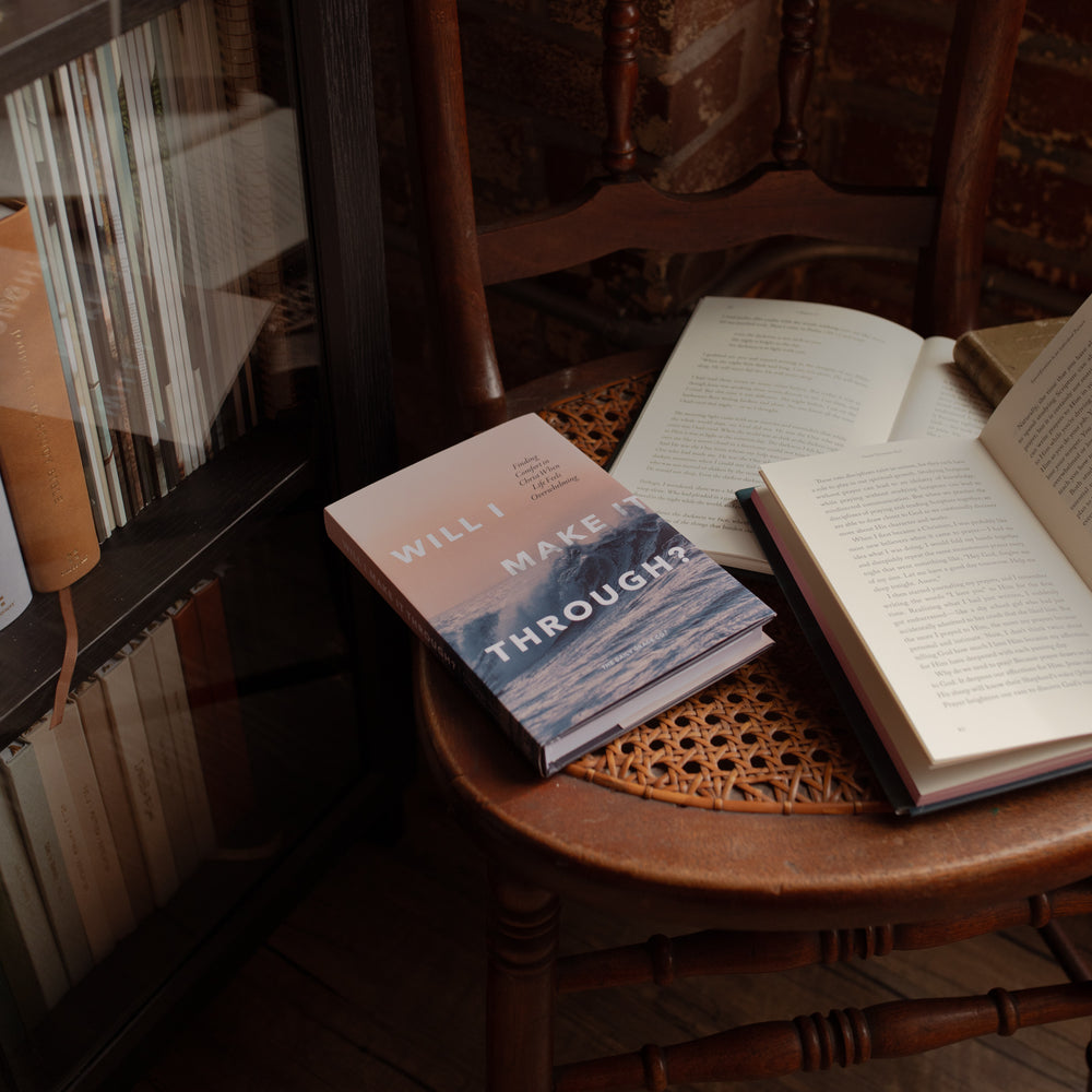 Will I Make It Through hardcover cover on a wooden and woven chair near an open book