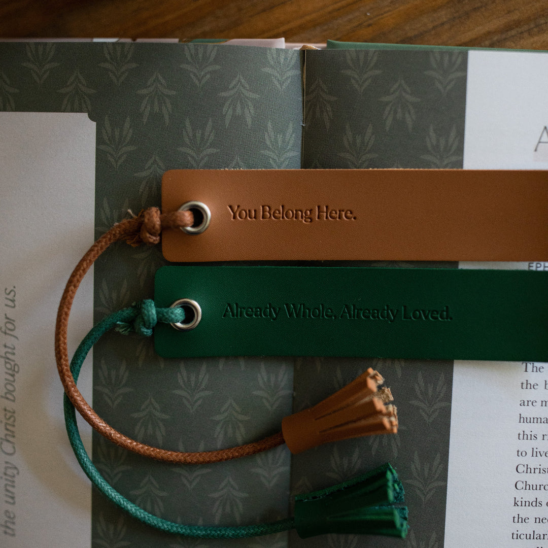 Close up of You Belong Here Leatherette Bookmarks laying on a open bible study on a wooden table