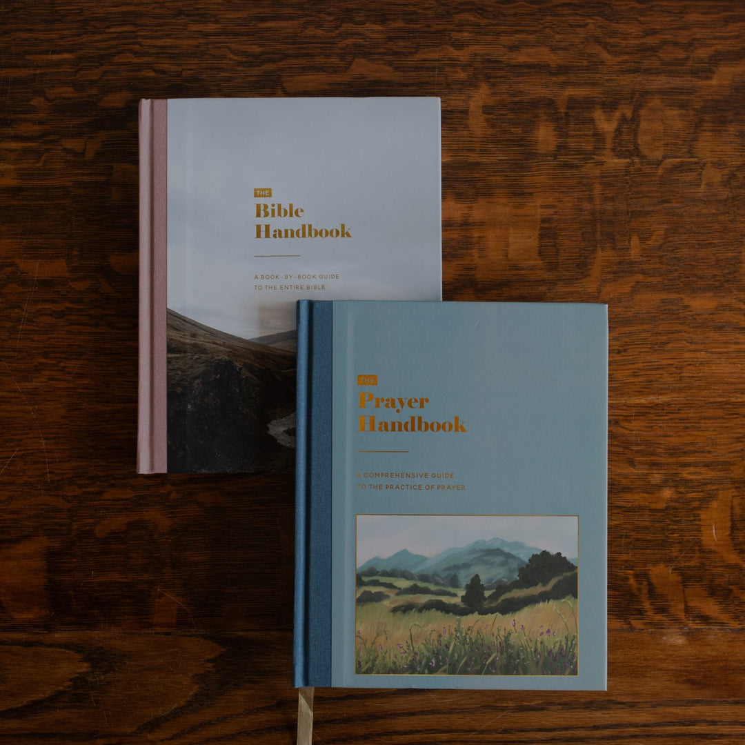 The Bible Handbook and the Prayer Handbook on a wooden table