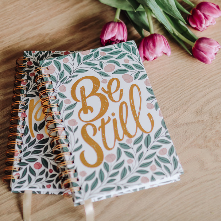 Bible study and prayer journal on table