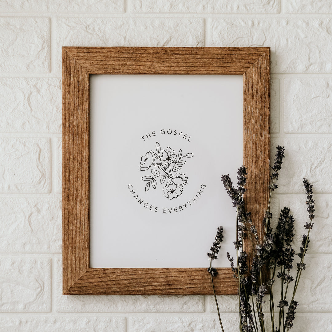 art print in wooden frame on wall