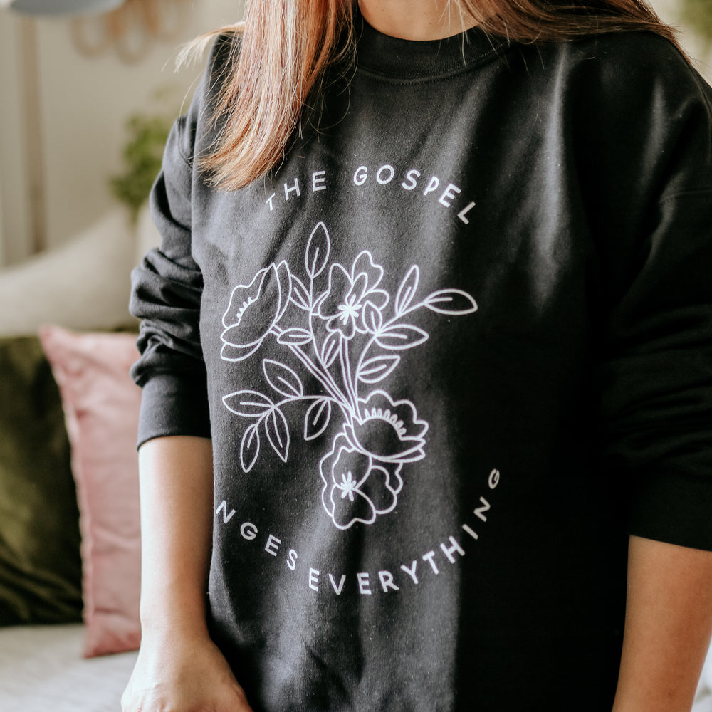 woman wearing black sweatshirt with white writing