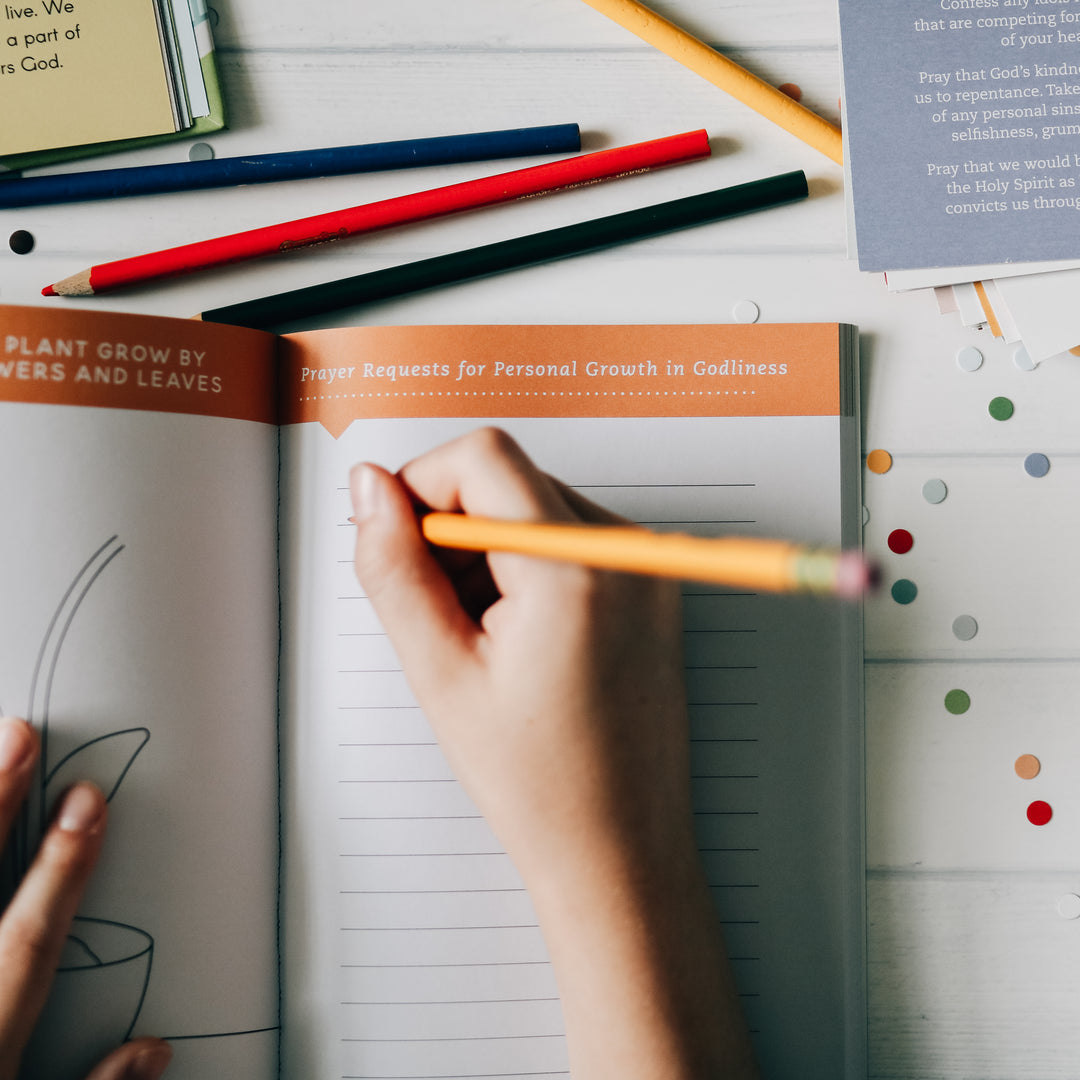 photo of child writing in booklet