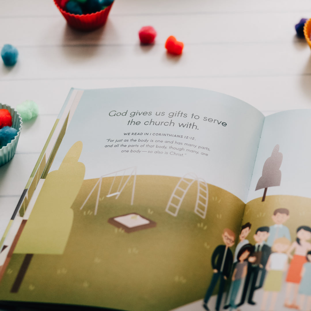 Children's book open to pages with writings and drawings on it