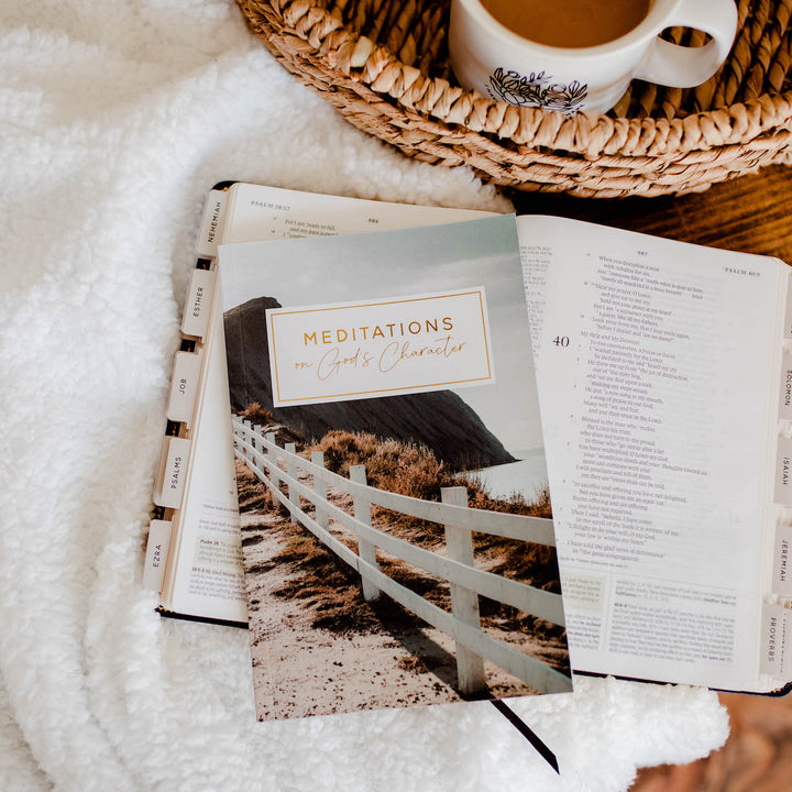 Meditations on God's Character is laying on top of an open Bible