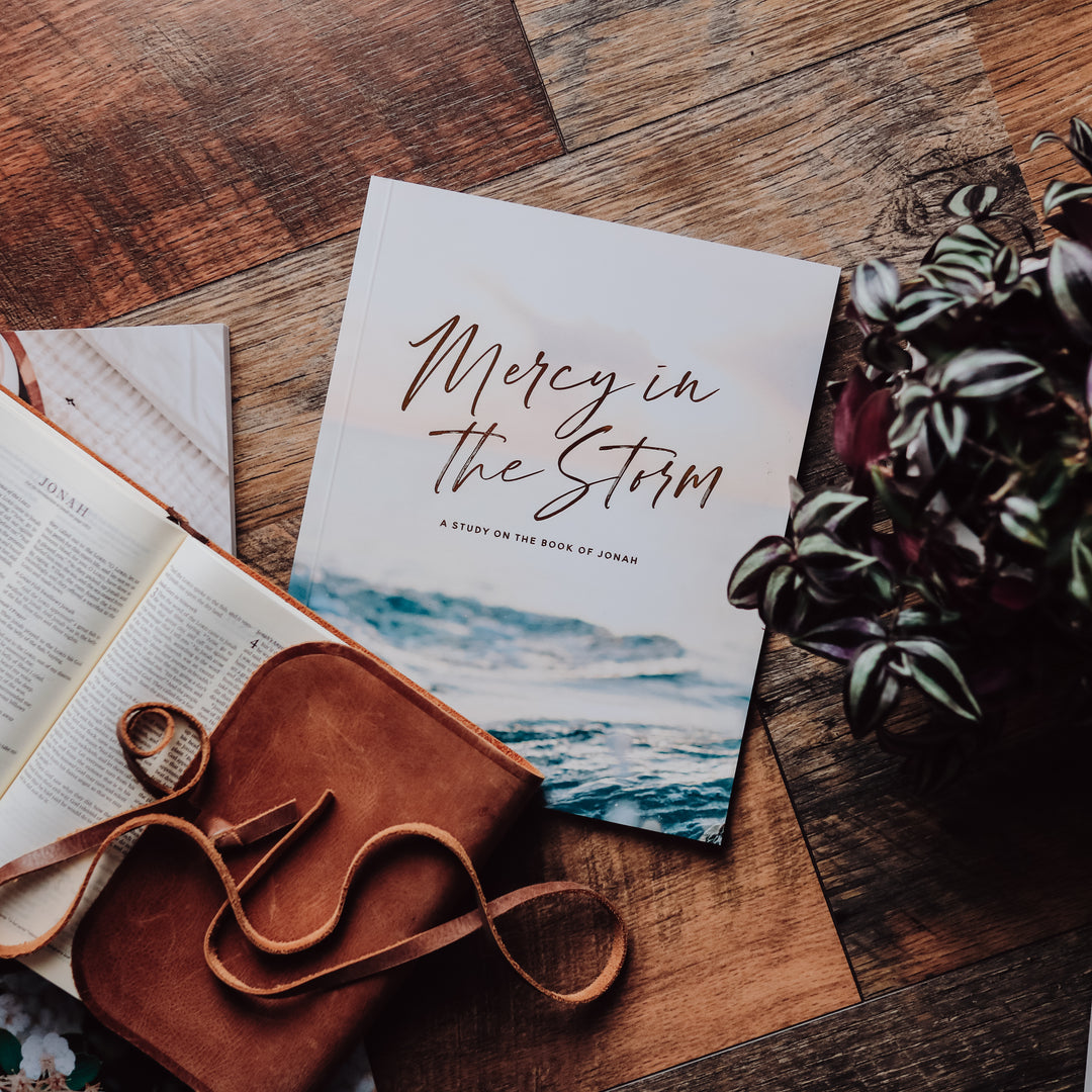 Mercy in the Storm: A Bible study on the Book of Jonah cover page next to a Bible