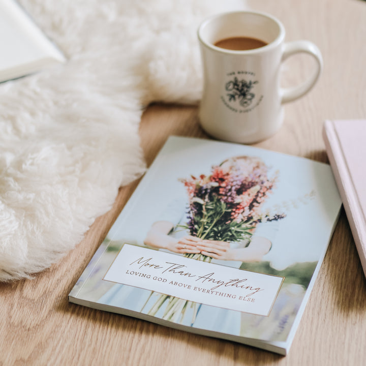 More Than Anything: Loving God Above Everything Else is closed on top of a table next to a Daily Grace coffee mug