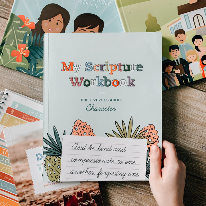 My Scripture Workbook: Bible Verses About Character is surrounded by Daily Grace children books. It's cover page is being held up by a child's hand. 